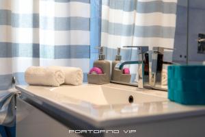 a bathroom sink with a towel and a mirror at Seaview Flat by PortofinoVip AC, Parking,Terrace in Rapallo +22 photos