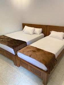 two beds sitting next to each other in a room at BSH (Bu Sud's House) Yogyakarta in Yogyakarta