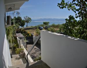 a stairway leading up to a house with a view of the water at 3 Waves Hotel in Huu
