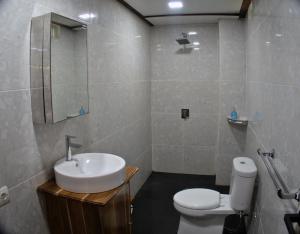 a bathroom with a sink and a toilet at 3 Waves Hotel in Huu