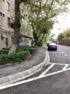 a street with a car parked on the side of the road at Central Vanilla Oradea in Oradea