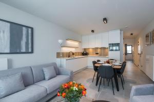 sala de estar con sofá y mesa en Belcasa Mar Suites & Lofts, en Middelkerke
