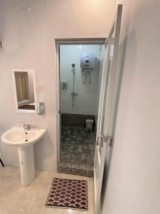 a bathroom with a shower and a sink at BSH (Bu Sud's House) Yogyakarta in Yogyakarta