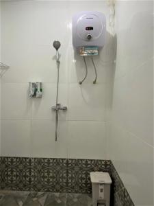 a bathroom with a toilet with a camera on the wall at BSH (Bu Sud's House) Yogyakarta in Yogyakarta