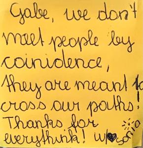 a letter written in cursive handwriting on a yellow paper at Gabe's Rooms in Central London in London