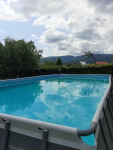 a large blue swimming pool on a balcony at Kipi Casa Family Apartment 3+2 with living room in Lazany