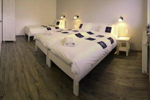 a bedroom with two beds with white and black sheets at Kipi Casa Family Apartment 3+2 with living room in Lazany