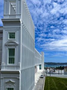 a white building with a fence on the side of it at Apartment Ajuda Tagus (ground floor) in Lisbon