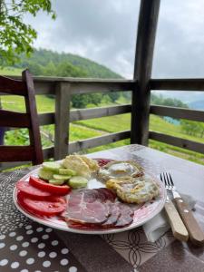 a plate of meat and vegetables on a table at Katun Lanista-Kolibe Bogavac in Mojkovac