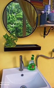 a bathroom sink with a mirror and a soap bottle on it at New Garden View GF Double Room FREE parking in Batu Unjor