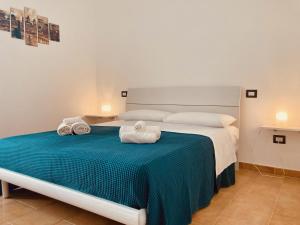 Postel nebo postele na pokoji v ubytování B&B Sabbia e Sassi