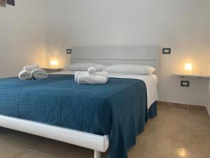 Postel nebo postele na pokoji v ubytování B&B Sabbia e Sassi