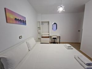 a bedroom with a large white bed in a room at Villa White in Ksamil