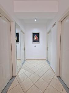 a hallway with white walls and a tile floor at Villa White in Ksamil