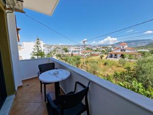 a balcony with a table and chairs and a view at Villa White in Ksamil