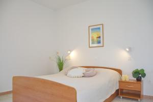 a bedroom with a bed with a stuffed animal on it at SeaSide VARSAN in Borovići