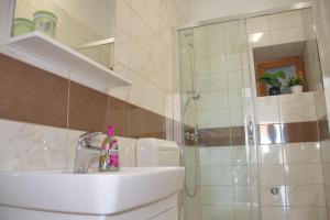 a bathroom with a sink and a shower at SeaSide VARSAN in Borovići +44 photos
