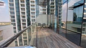 a balcony of a building with a table and chairs at Furnished apartment in Damac Tower. Jordan in Amman