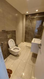 a bathroom with a toilet and a sink at Furnished apartment in Damac Tower. Jordan in Amman