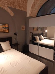a bedroom with two beds and a large window at Urban79 in Bernalda