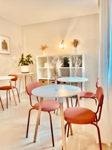 a dining room with two tables and chairs at Hostal Lóbrega in Torrecilla en Cameros
