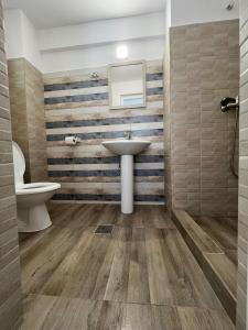 a bathroom with a sink and a toilet at Complex Marea Neagra in Eforie Nord
