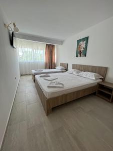 a bedroom with two beds in a room at Complex Marea Neagra in Eforie Nord