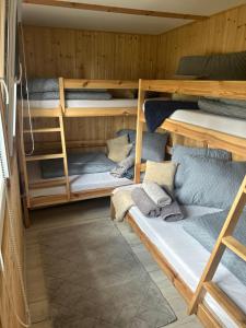 a room with four bunk beds in a cabin at Domek Wakacyjny Maciuś 48 in Głębokie