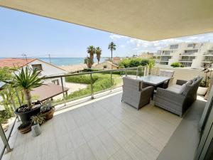 a balcony with a table and chairs and the ocean at Tierra de Mar 50 in Denia