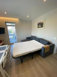 a room with a bed and a couch in it at Urbas Sea view apartment in Nida
