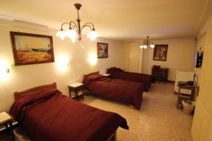 ein Wohnzimmer mit 2 Betten und einem Sofa in der Unterkunft Hotel Hydra in Alger
