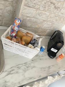 einen Korb Brot und ein Telefon auf dem Tresen in der Unterkunft Nyx Dea Della Notte in Bari