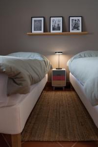 a bedroom with two beds and a night stand with a lamp at Casa La Rosa with private pool in Loja de Vendas