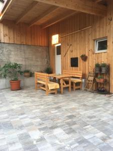 a patio with benches and a table and a television at Ferienwohnung in Wiesent-gerne Handwerker/Monteure in Wiesent