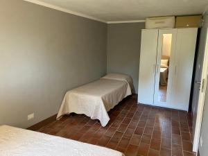 a room with two beds and a door to a bedroom at Rivolta home in Buti