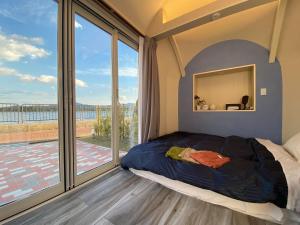 a bedroom with a bed and a large window at The Gran Resort Amanohashidate in Miyazu