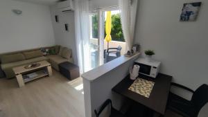 a small living room with a couch and a table at Apartment Iva&Andro in Koločep