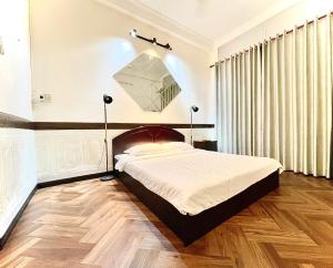 Postel nebo postele na pokoji v ubytování BÊ TÔNG RESIDENCES HOMESTAY