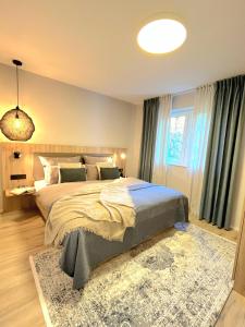 a bedroom with a large bed and a rug at Maison Saarschleife Mettlach in Mettlach