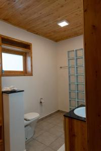 a bathroom with a toilet and a sink at Umutuzo lodge Kivu lake 