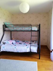 a bedroom with two bunk beds in a room at Maison charentaise in Pons