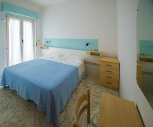 1 dormitorio con 1 cama, 1 mesa y 1 silla en Albergo Il Veliero, en Pineto