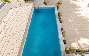 an overhead view of a large blue swimming pool at Cozy Apartment In Crikvenica With Heated Swimming Pool in Crikvenica