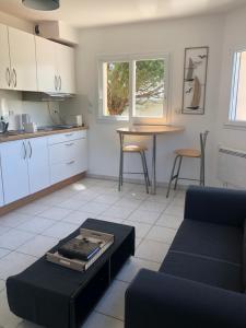 a living room with a couch and a table at L’évidence in Ploudalmézeau