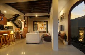 a living room with a couch and a table at Sudha Villa Bali Anyelir in Seminyak