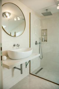 a white bathroom with a sink and a shower at ANNO Apartment Imotski-Makarska in Imotski +42 photos