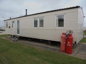 a white trailer with two fire hydrants in front of it at Coral Beach : The Richmond:- 6 Berth, Blow heated in Ingoldmells