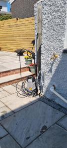 a house with a power cord hooked up to a building at Viaduct View - Cefn Coed in Merthyr Tydfil