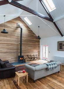 a living room with a couch and a fireplace at CHESTER'S ONLY TIN CHAPEL - UNIQUE, SPACIOUS 2 BEDROOMS, GARDEN AND FREE PARKING in Chester