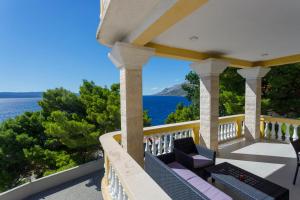 a balcony with chairs and a view of the ocean at Apartments Beach Side Brela in Brela